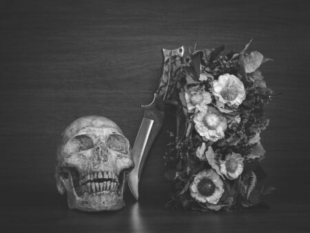 Still life with human skull and knife and dry flowers, Vintage styleの写真素材