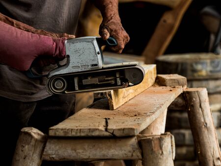 Professional technicians in the factory are using power tools to polish the wooden, To be used in...