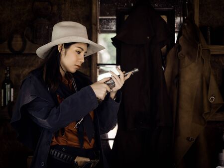 Western girl cowgirl prepares for the ammunition to be defended by gunfire in a land where people must protect themselves, Since it was an era where the law had not yet been reachedの写真素材