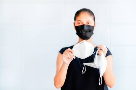 Asian women have to use masks and face shields to protect against pollution from dust and to prevent infections from secretions that spread in the air, during the outbreak of the corona virus throughout the worldの写真素材