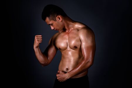 A strong Asian man raised his arms to show his strong and beautiful muscles from exercise to build...