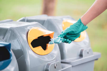 Disposable face masks are infectious waste and are thrown away in public areas, unsuitable to be used with other wasteの写真素材