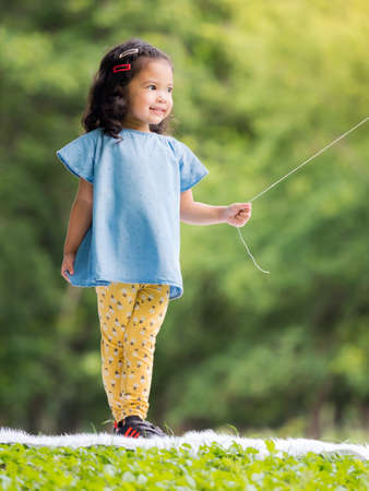 Asian little girl standing  on the carpet, Playing and learning outside of school to enjoy in the...