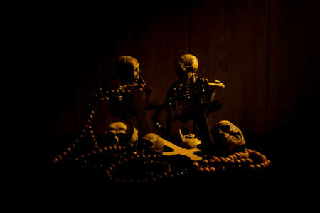 Still life art of a human skull and bead on a black backgroundの写真素材