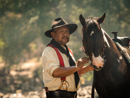 Old cowboy rested with a horse in the stream after he finished showering the horse