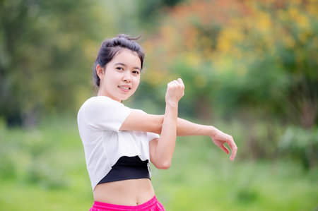 A beautiful Asian woman is warm up, To make the muscles flexible Before going to jogging for good health and energy metabolismの写真素材