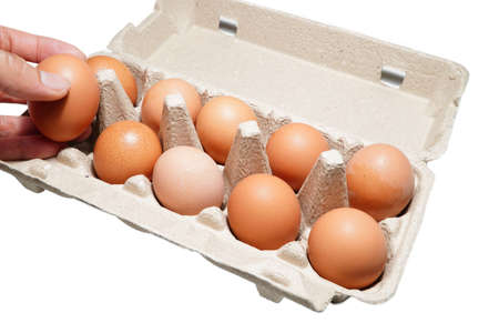 Chicken eggs with a hand, a man picked medical on an egg box, coronavirus, covid-19, photos, concept, isolated advertisingの写真素材