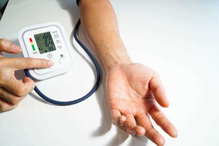 Men's health check blood pressure.and heart rate with digital pressure gauge standard blood pressure test results .Health and Medical conceptの写真素材