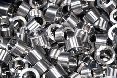 Shiny steel parts background. Regular industrial metal production pattern with selective focus.High precision steel automotive parts manufacturing by innovative CNC machiningの写真素材