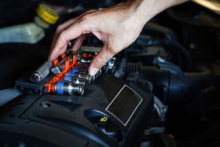 Auto mechanic working in garage. Repair service,Car check concept