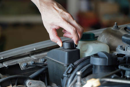 Asian technicians inspect brake fluid for engine compartment care and basic service concept of the vehicle and braking system.の写真素材