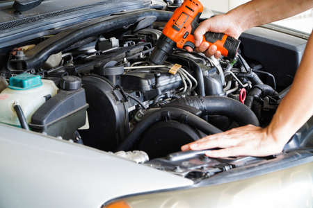 Asian technicians inspect brake fluid for engine compartment care and basic service concept of the vehicle and braking system.の写真素材