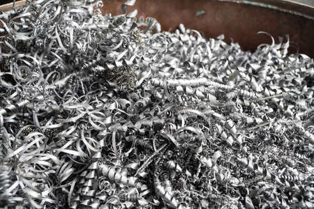 Steel scrap materials recycling. Aluminum chip waste after machining metal parts on a cnc lathe....
