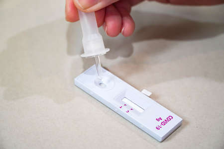 Positive test result by using rapid test for COVID-19, quick fast antibody point of care...