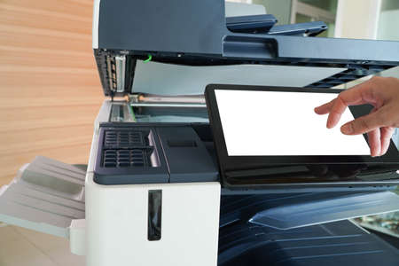Men press the button of the copier. Man copying paper from Photocopier. Men use printing machines....
