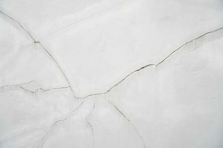 cracked concrete wall covered with gray cement surface as background