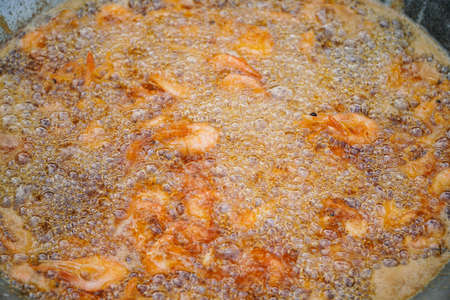 Fresh shrimp fried in a pan in hot oil