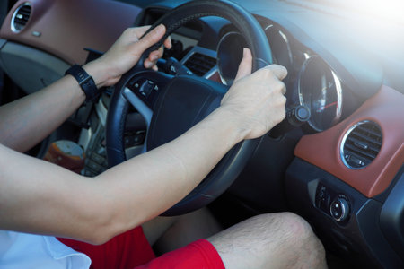 Young man driving a modern car on vacationの写真素材