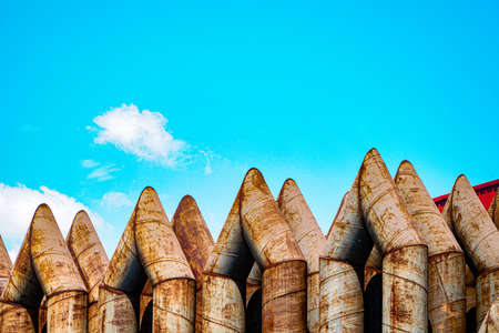Large factory exhaust pipe blue sky backgroundの写真素材