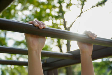 Kids hanging on the bar at the playground
