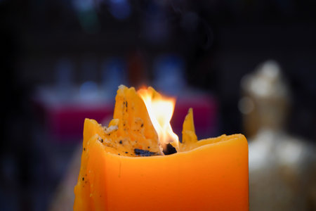candle flames illuminate the day of buddhist lentの写真素材