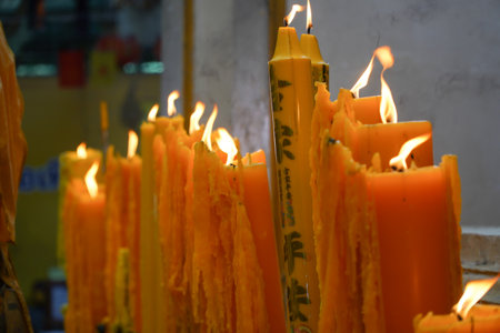 candle flames illuminate the day of buddhist lentの写真素材