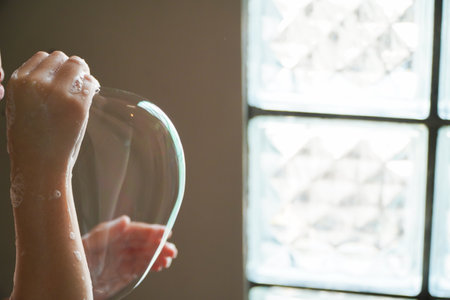 Asian girls play with soap bubbles in the bathroom.