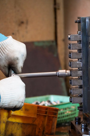 worker is locking the workpiece on the cnc machine.
