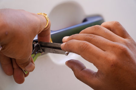 Person's Young Man Locksmith Hand Opening white  Car Door With Lock picker.Locksmith door opening...