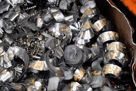 Steel scrap materials recycling. Aluminum chip waste after machining metal parts on a cnc lathe....