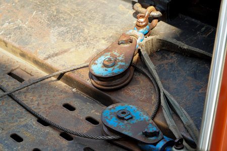 Hoist chains, chain hook wheel alignment, Chain hoists for heavy lifting, tow black crane hooks on a...