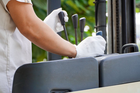 Asian male worker drives a forklift in an industrial factory. This is distribution and warehouse.Concept of new normal work in logistic industryの写真素材