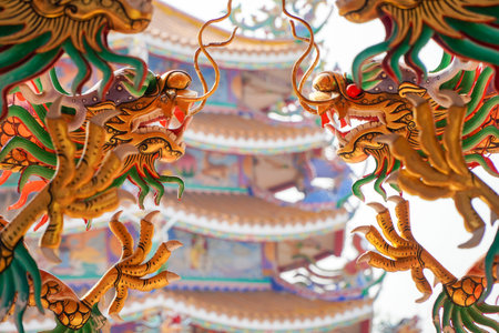 Colorful statue of Chinese dragon wrapped around the pillar. Beautiful statue of dragon carved around temple pole in Chinese public temple.の写真素材