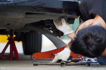 Wheel House Liner Set,Asian mechanic installs new plastic wheel arches,car service stationの写真素材