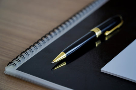 Notebook and pen on wooden table. Business concept. top view with copy space, copy space for office work text.の写真素材