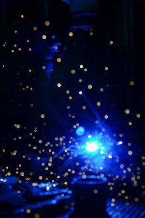 sparks from welding at night in a factory, close-upの写真素材