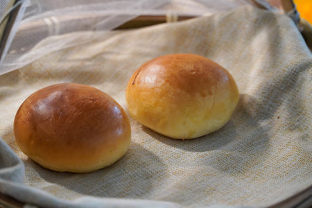Buttermilk Dinner Buns,Freshly baked buns on a linen napkin.Buttermilk Dinner Buns.
 Close-up.