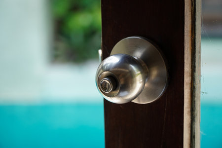 Door knob in the swimming pool with blue water background. Selective focus.の写真素材