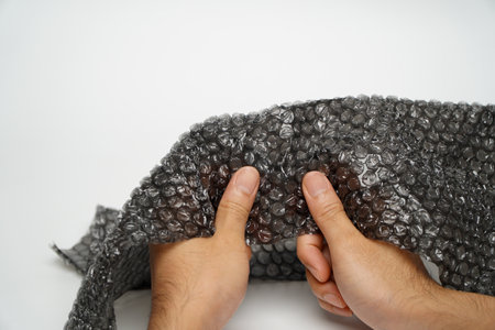 Male hand popping  wrap isolated on white background,anger managementの写真素材