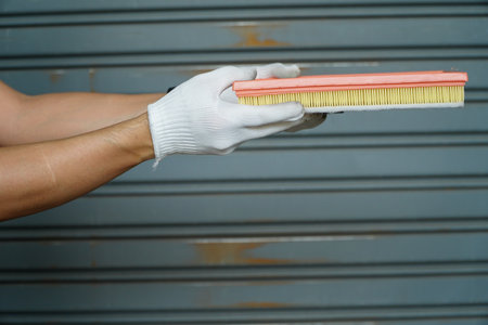 Hand of worker cleaning metal door with brush. Housework concept.の写真素材