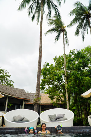 Unidentified people relaxing in swimming pool at luxury resort.の写真素材