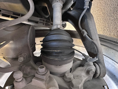 Tie rod end or ball joint,Left driveshaft of front axle with disc brake and ball joint, service center is replacing the driveshaft in the garage.の写真素材