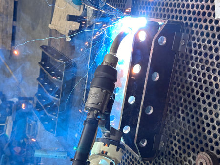 Industrial robots are welding in a car body factory,The concept of using robots to work instead of humans.の写真素材