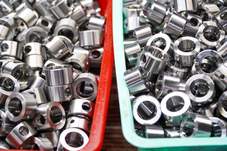 Shiny steel parts background. Regular industrial metal production pattern with selective focus.High...