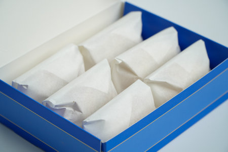 blue cardboard box containing white snacks.の写真素材