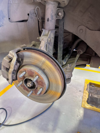 Car brake disc and brake pads on the lift in the car serviceの写真素材