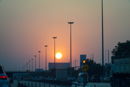 Sunset during Friday evening traffic on a highway in Thailand