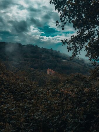 Small church in the middle of a huge forest on a cloudy day, Sanctuary of Our Lady of the Rosary, Candeleda, Avila.の写真素材