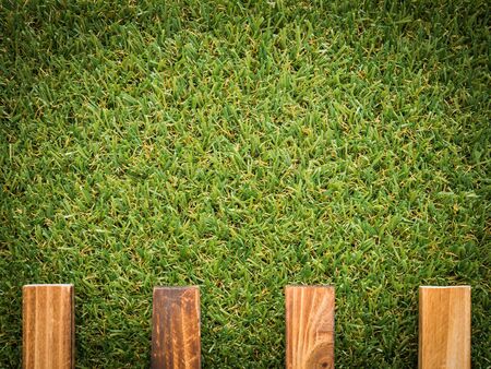 background with garden fence and green grass in vignette styleの写真素材