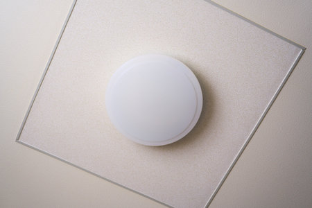Simple round white ceiling light fixture in a room